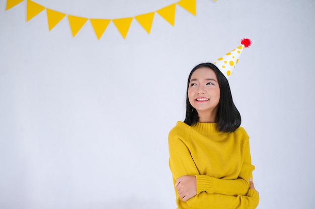 Young girl wear yellow sweater on party background