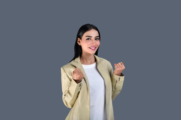 Young girl wearing jacket front pose with fists feeling happy indian pakistani model