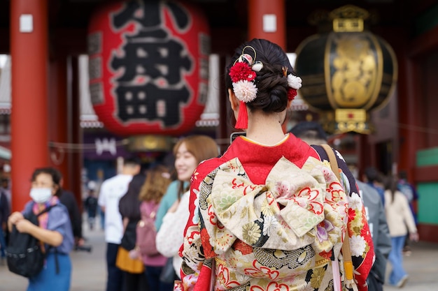 東京の浅草寺の前に立つ日本の着物を着た若い女の子 着物は日本の伝統的な衣服です 着物という言葉は実際に着る物を意味します