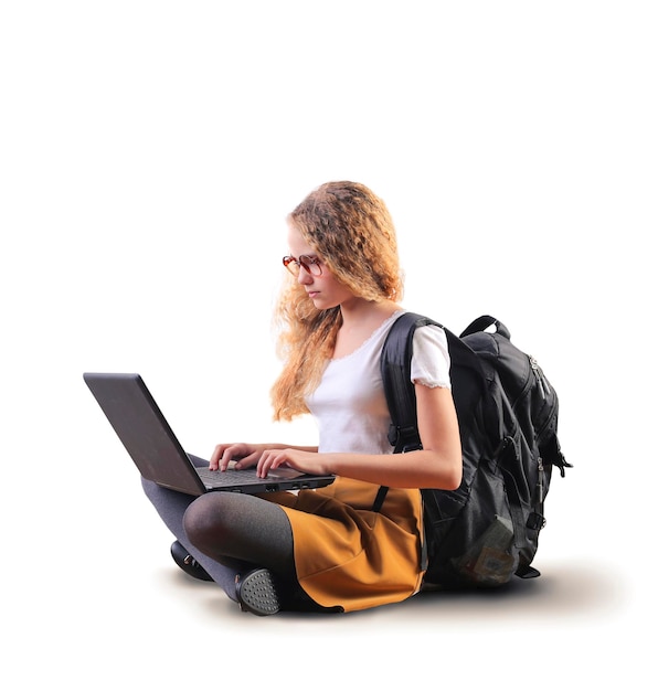 young girl on a white background with a laptop