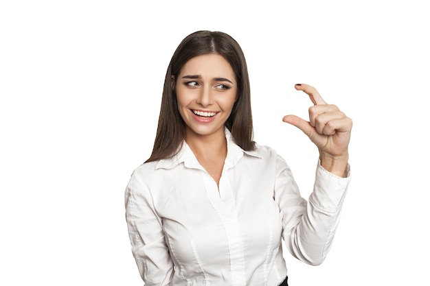 Young girl in white blouse showing Its so small