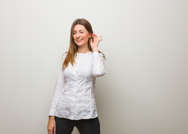 Young girl winking, funny, friendly and carefree gesture