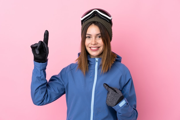 Young girl winter hat over blue wall