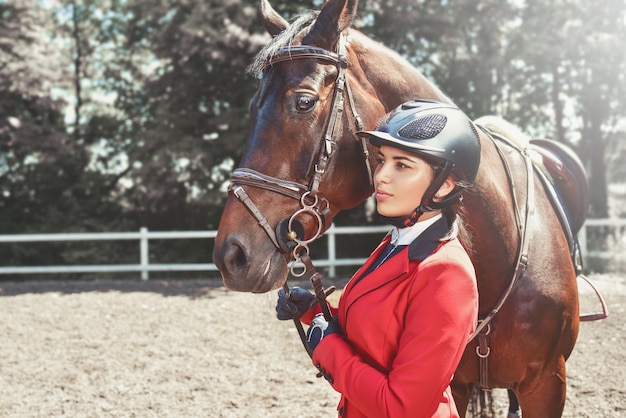 Young girl with a big brown horse