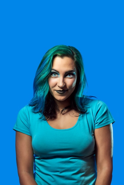 A young girl with blue hair on a blue background