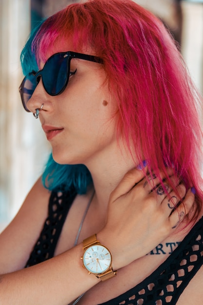 Young girl with blue and pink hair and sunglasses