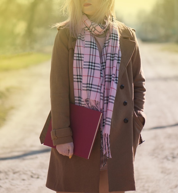 Young girl with book in the street Beautiful girl with pink hair with books outdoors