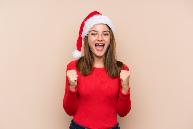 Young girl with christmas hat celebrating a victory