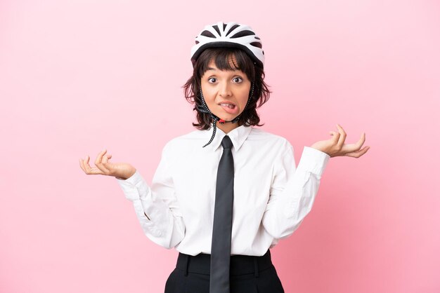 Young girl with christmas hat over isolated background with fingers crossing