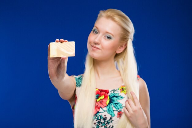 Young girl with a credit card in focus