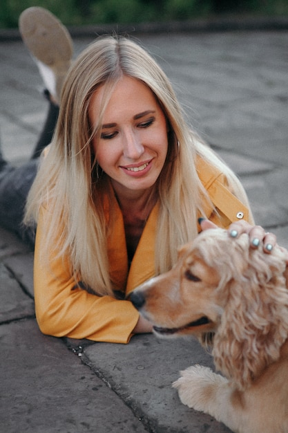 Young girl with dog walks in the park 