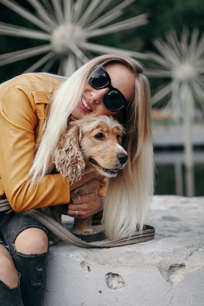 Young girl with dog walks in the park