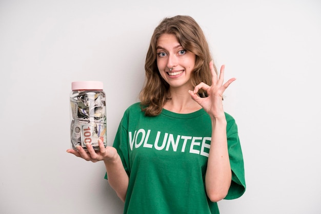 Young girl with a donation banknotes bottle volunteer concept