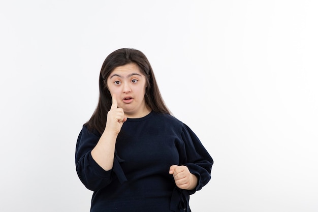young girl with down syndrome standing and posing.