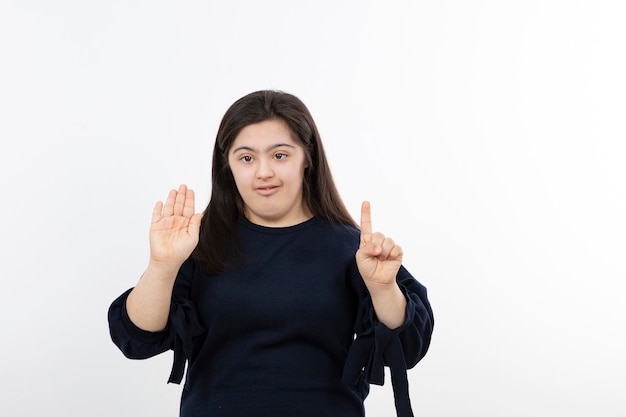 young girl with down syndrome standing and posing.