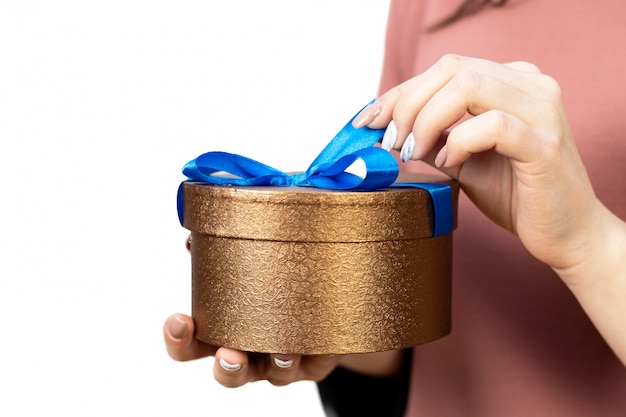 Young girl with a gift box with blue bow