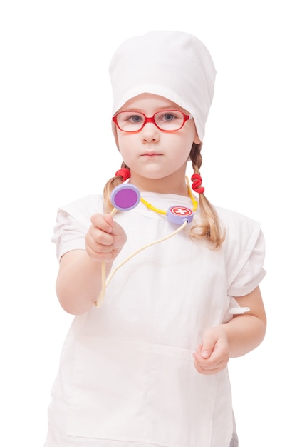 Young girl with glasses plays in the doctor as a mom