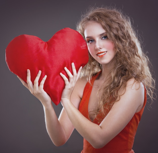 Young girl with a heart in his hands