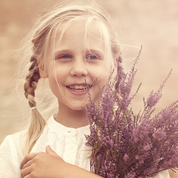 Young girl with heather flowers