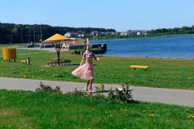 Young girl with her dog. puppy white dog is running with it's owner. conception about friendship, animal and freedom