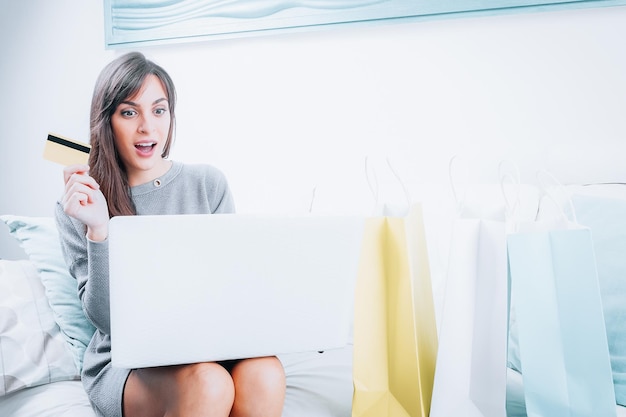 Young girl with laptop computer make a shopping closeup