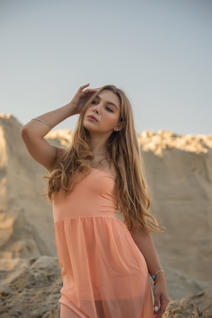 Young girl with long blond natural hair in summer