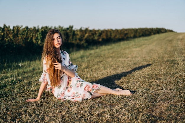 Young girl with long curly hair and freckles