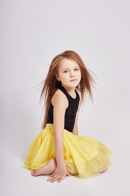 Young girl with long hair posing on white