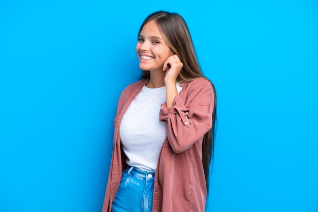 Young girl with lots of different mini cakes with fingers crossing