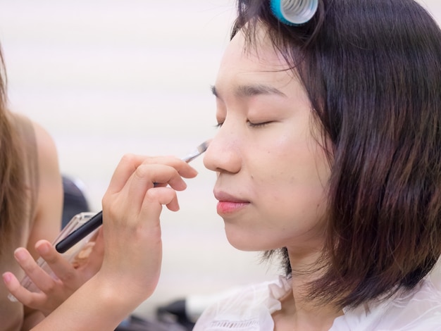 Young girl with makeup cosmetics