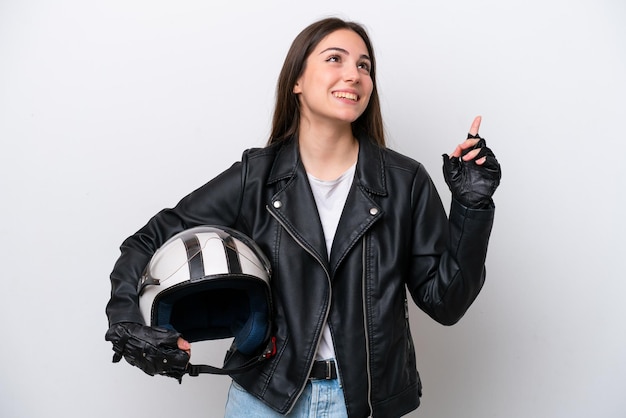 Young girl with a motorcycle helmet isolated on white background pointing up a great idea