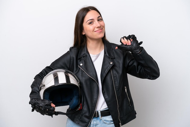 Young girl with a motorcycle helmet isolated on white background proud and selfsatisfied