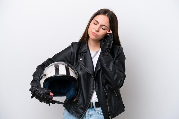 Young girl with a motorcycle helmet isolated on white\
background with headache