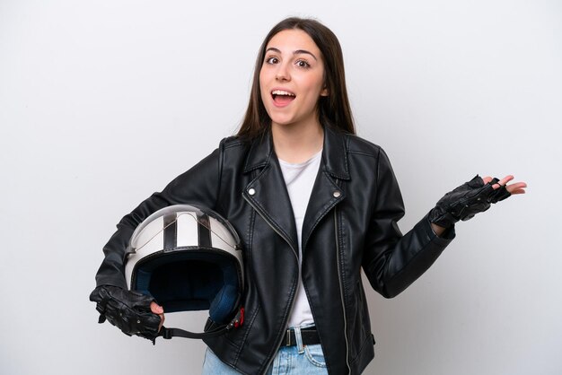 Young girl with a motorcycle helmet isolated on white\
background with shocked facial expression