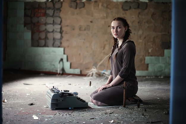 A young girl with old books in the old house