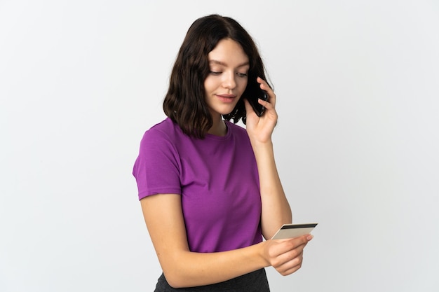 Young girl with phone on isolated white