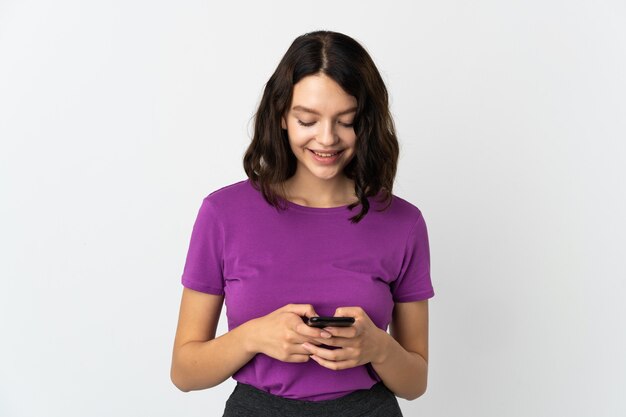 Young girl with phone on white