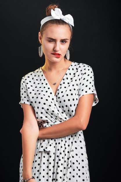 Young girl with pin-up make-up and hairstyle showing different emotions.