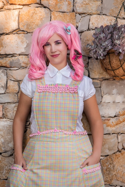 Young girl with a pink wig posing as a housewife.