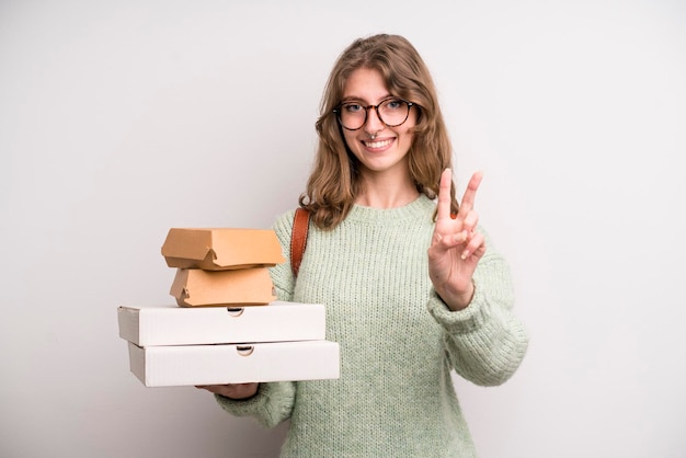 Young girl with pizzas and burgers take away fast food concept