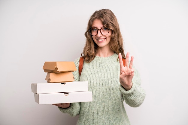 Young girl with pizzas and burgers take away fast food concept