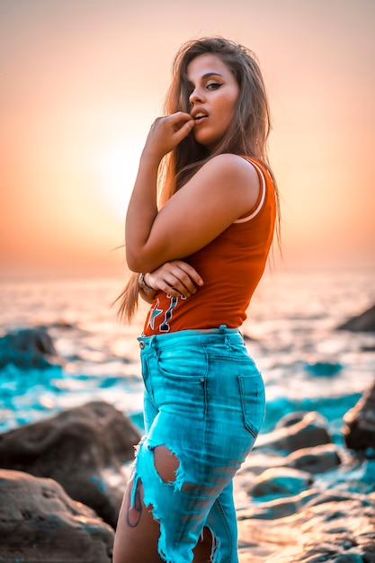 A young girl with red shirt enjoying a sunset in the Basque Country