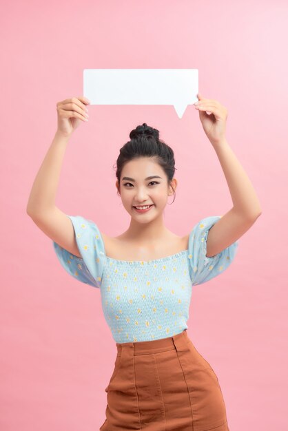 Young girl with speech bubble on pink background