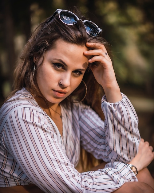 A young girl with a striped shirt in a lifestyle session and wearing sunglasses