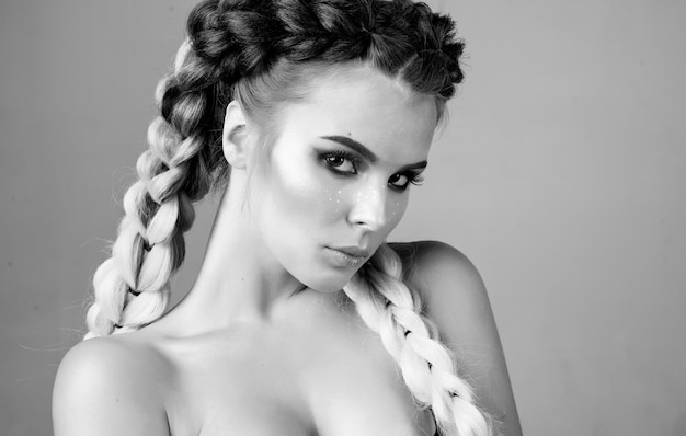 Young girl with two pigtails portrait of a fashion girl with braids beautiful womans face hair braid