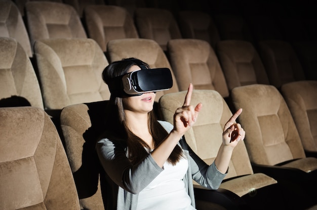 Young girl with virtual reality glasses in a soft chair.