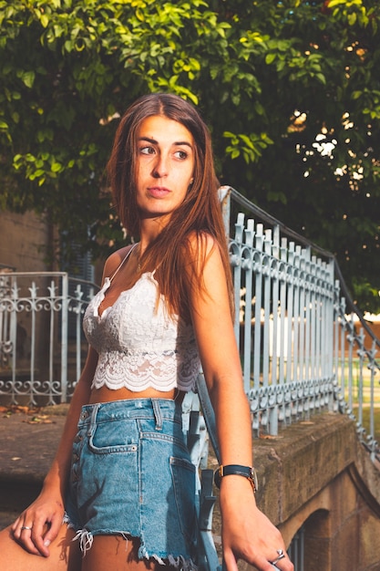 Young girl with a white shirt and blue short jeans