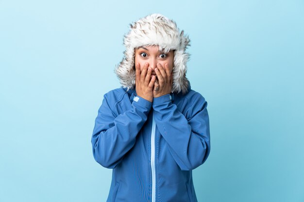 Young girl with winter hat over isolated wall