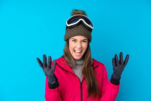 Young girl with winter hat over isolated wall