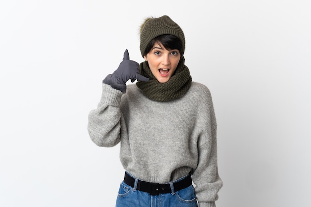 Young girl with winter hat making phone gesture. Call me back sign